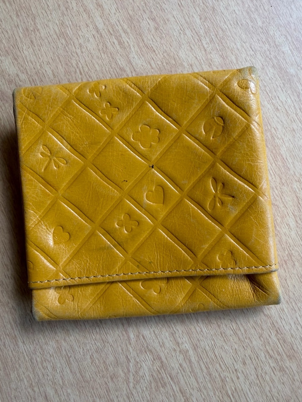 Brighton yellow leather wallet features a distinctive embossed pattern